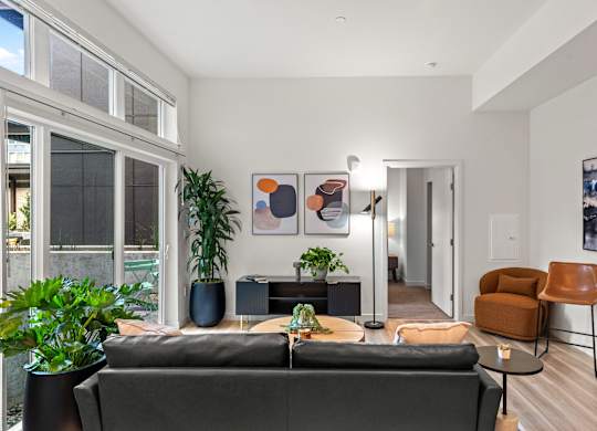 a living room with a couch and a coffee table and a large window at Baldwyn, Washington, 98125