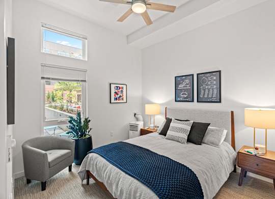 a bedroom with a large bed and a ceiling fan at Baldwyn, Seattle, WA 98125