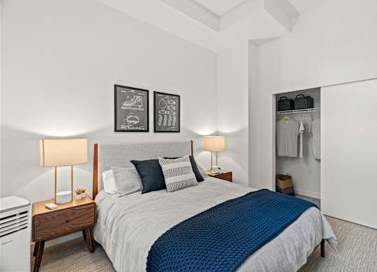 a bedroom with a bed and a closet at Baldwyn, Seattle Washington