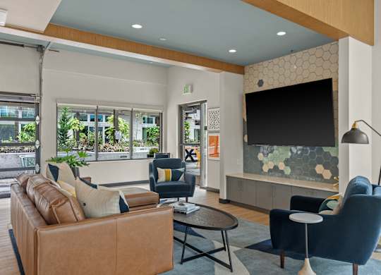 a living room with couches and chairs and a television at Baldwyn, Seattle Washington