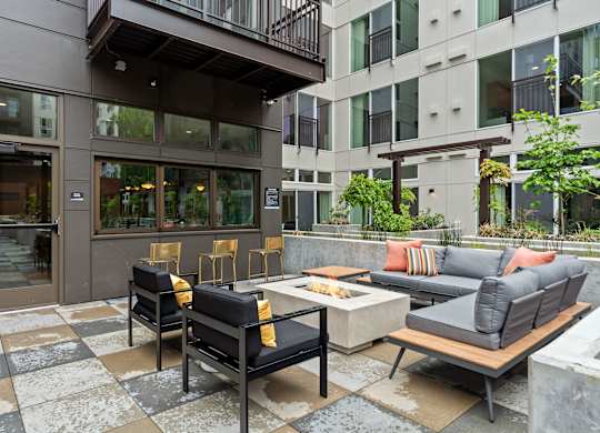 a living room with couches and chairs and a table in front of a building at Baldwyn, Washington, 98125
