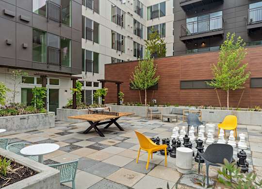 an outdoor patio with tables and chairs at an apartment complex at Baldwyn, Washington