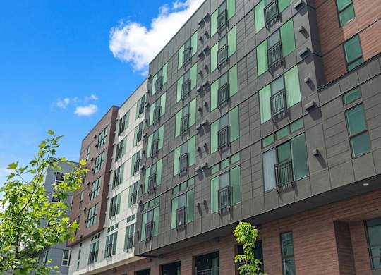 a tall building with green windows and a blue sky at Baldwyn, Washington, 98125