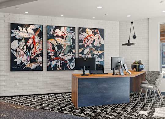 an office with three paintings on the wall and a desk with a computer at Gage On Sixth, Tacoma