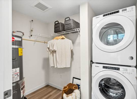 a laundry room with a washing machine and a washer and dryer