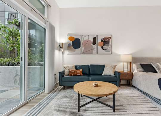 a living room with a blue couch and a coffee table