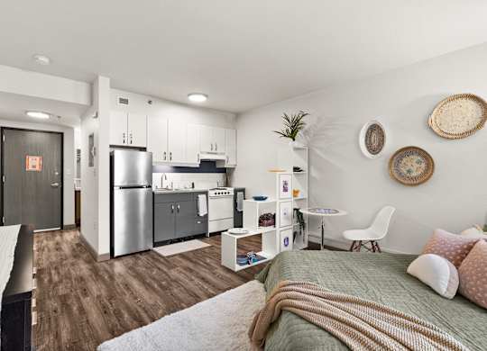 A modern kitchen with a refrigerator, sink, and cabinets.