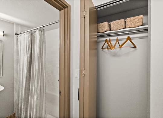 A white bathroom with a shower curtain and a white sink.
