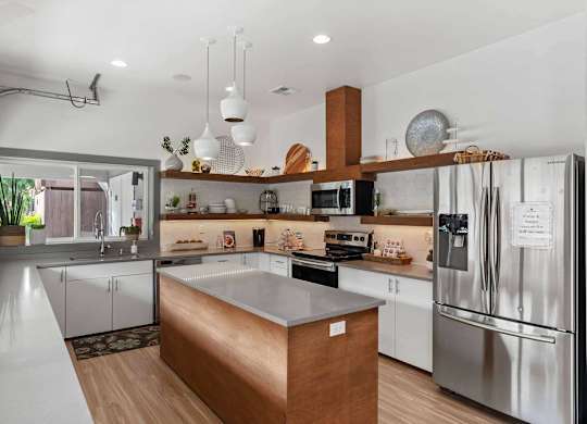 A modern kitchen with a wooden island in the middle. at Northpoint Apartments, Washington, 98407
