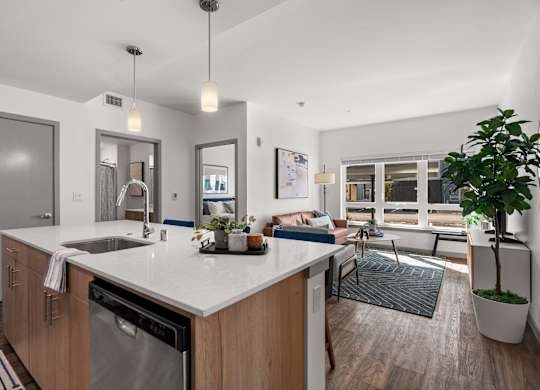 a kitchen with an island and a living room with a couch at Gage On Sixth, Tacoma, WA 98406