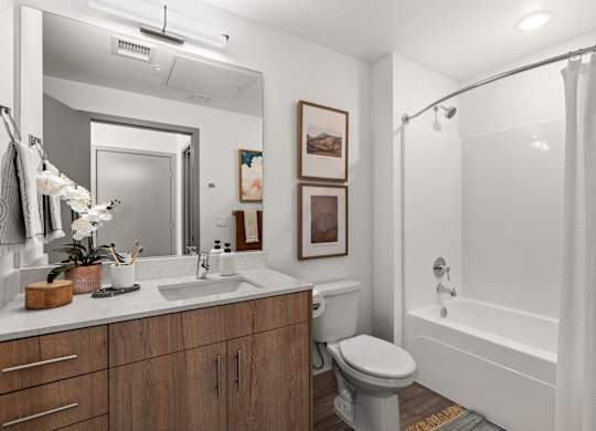 a bathroom with a shower toilet and sink and a mirror at Gage On Sixth, Tacoma, 98406