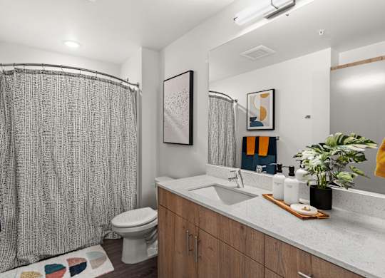 a bathroom with a shower and a sink and a toilet at Gage On Sixth, Washington, 98406