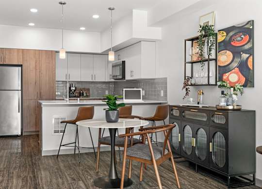 an open kitchen and dining area with a table and chairs at Gage On Sixth, Tacoma, WA 98406