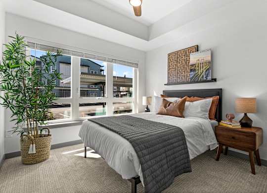 a bedroom with a large window and a bed at Gage On Sixth, Washington