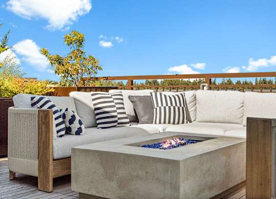 a seating area with a couch and a fire pit on a patio at Baldwyn, Seattle