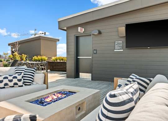 a patio with a couch and a fire pit at Baldwyn, Seattle, WA