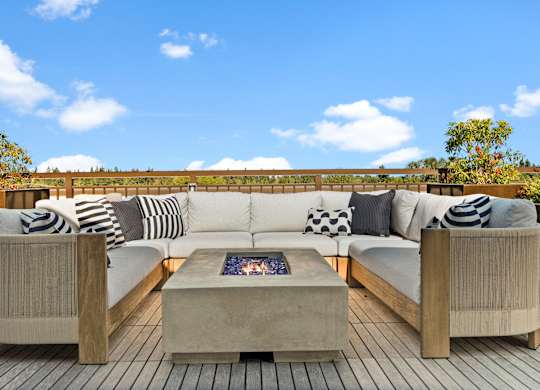 a living room with a large couch and a coffee table on a deck at Baldwyn, Seattle, WA 98125