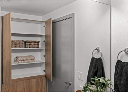 a small bathroom with a closet and a door to the shower at Gage On Sixth, Tacoma