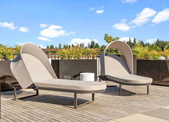 a couple of white chairs sitting on a wooden deck at Baldwyn, Seattle, WA 98125