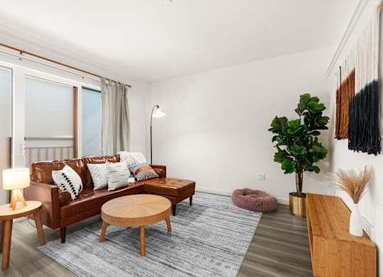 a living room with a couch and a coffee table at Baldwyn, Seattle, 98125