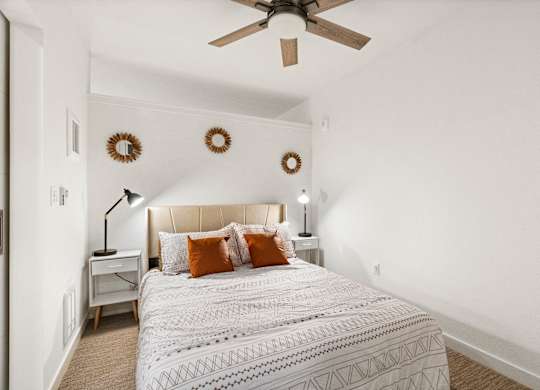a bedroom with a bed and a ceiling fan at Baldwyn, Seattle, 98125