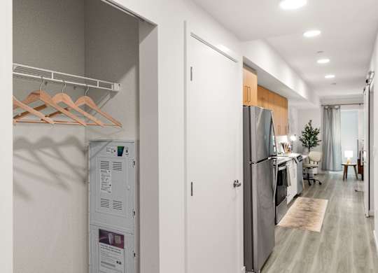 a kitchen and living room with a refrigerator and a washer and dryer at Baldwyn, Seattle, 98125