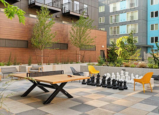 a game of chess on a table with chairs in a courtyard at Baldwyn, Washington