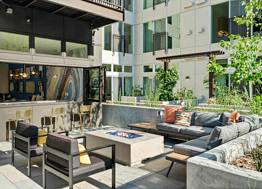 a living room with couches and chairs and a fire pit at Baldwyn, Seattle, WA 98125
