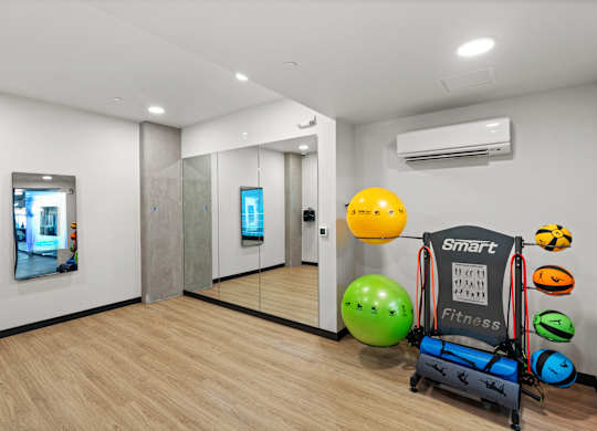 a workout room with a variety of weights and other exercise equipment at Baldwyn, Seattle, 98125