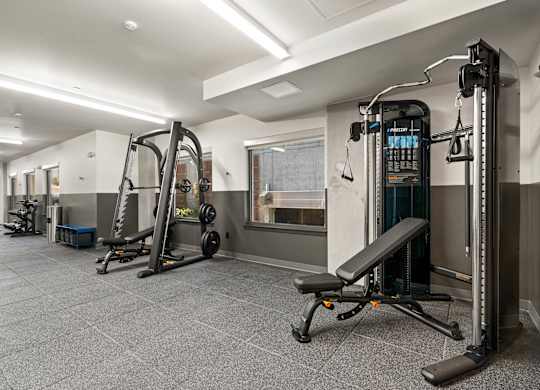 a gym with weights and other equipment in a building with white walls at Baldwyn, Washington