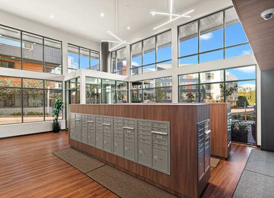 a large room with a desk with lockers and windows at Baldwyn, Seattle, WA