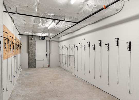 a row of white lockers in a room with inflated ceilings at Baldwyn, Seattle, WA 98125