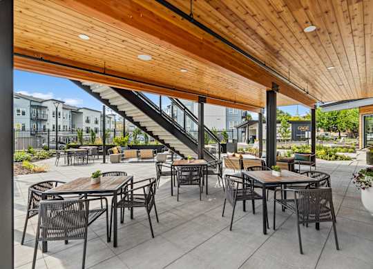 a patio with tables and chairs and a wooden ceiling at Gage On Sixth, Tacoma, WA