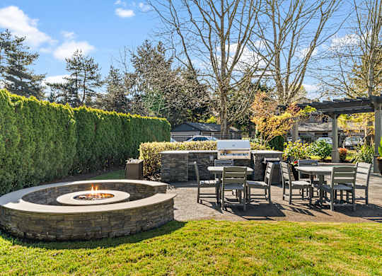 A backyard with a fire pit and seating area.