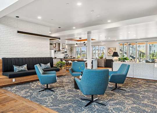 a living room with blue chairs and a couch at Gage On Sixth, Tacoma