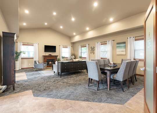A well-lit dining room with a table set for six.