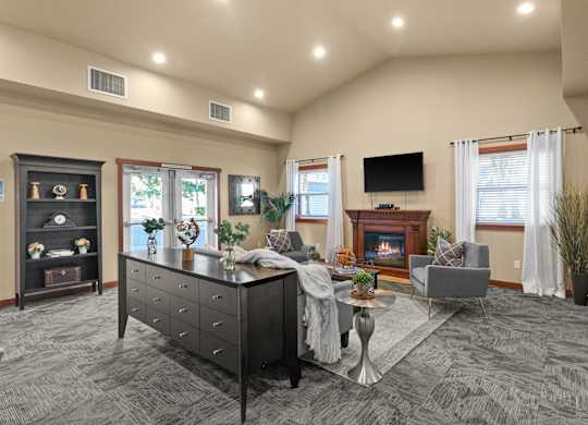 A spacious living room with a fireplace and a television.
