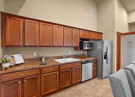 A kitchen with wooden cabinets and a refrigerator.