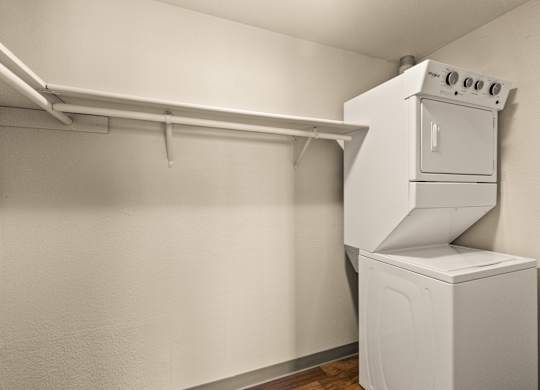 A white oven and dryer in a small room.