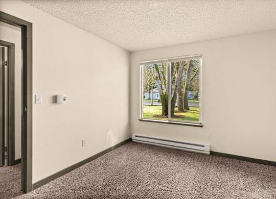 A room with a window showing trees outside.
