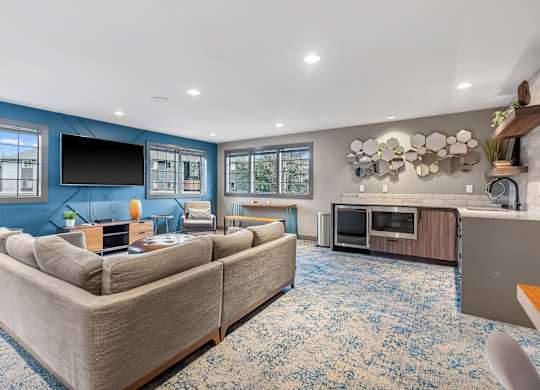 A living room with a large couch and a television.