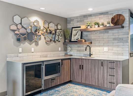 A modern kitchen with a stainless steel oven and wooden cabinets.