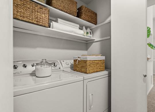 A white kitchen with a stove top oven and a dishwasher.