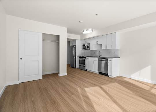 A kitchen with white cabinets and appliances is shown.