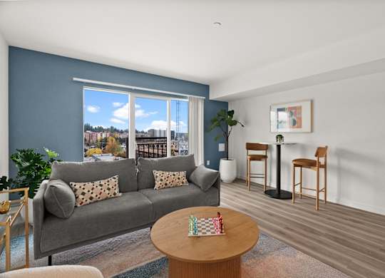 a living room with a couch and a table and a large window