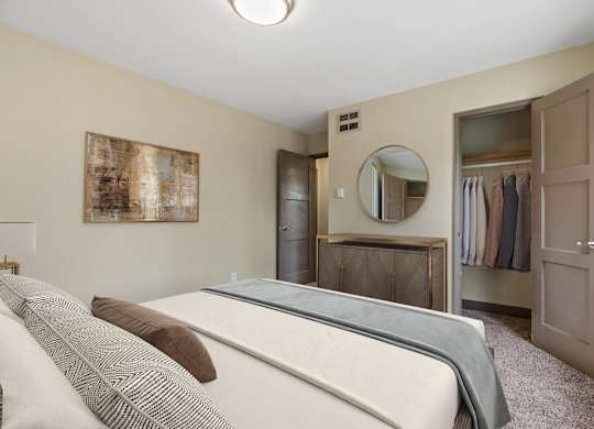 A bedroom with a bed, wardrobe, and a mirror.