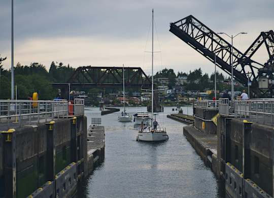 A boat is passing through a drawbridge.