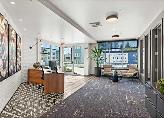 A modern office lobby with a reception desk and a couch.