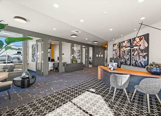 A black and white tiled floor in a modern room with a bar and chairs.