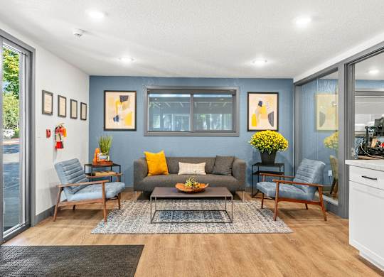 A living room with a grey couch and a coffee table.